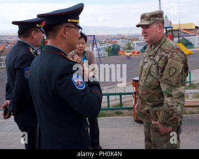 Alaska Army National Guard Col. Peter Mondelli, 297th Regional Support Group commander and Khaan Quest 18 exercise director, greets members of the Mongolian Armed Forces June 15, 2018, during a Health Services Support Element outreach in Ulaanbaatar, Mongolia. Khaan Quest 2018 is a regularly scheduled, multinational exercise co-sponsored by U.S. Pacific Command and hosted annually by the Mongolian Armed Forces. KQ18 is the latest in a continuing series of exercises designed to promote regional peace and security. This year’s exercise marks the 16th anniversary of this training event. Stock Photo