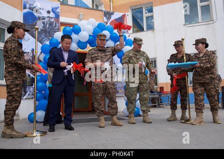 Mongolian Armed Forces Brig. Gen. L. Ganselem (third from left), exercise co-director for Khaan Quest 18, and Alaska Army National Guard Col. Peter Mondelli (fourth from left), 297th Regional Support Group commander and Khaan Quest 18 exercise director, participate in a ribbon cutting June 15, 2018, signifying the start of the Health Services Support Element outreach in Ulaanbaatar, Mongolia. Khaan Quest 2018 is a regularly scheduled, multinational exercise co-sponsored by U.S. Pacific Command and hosted annually by the Mongolian Armed Forces. KQ18 is the latest in a continuing series of exerc Stock Photo