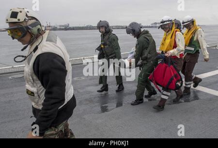 Japan (June 17, 2018) Sailors assigned to Military Sealift Command hospital ship USNS Mercy (T-AH 19) for Pacific Partnership 2018 (PP18) and Japanese Maritime Self-Defense Force (JMSDF) transfer a mock patient from an SH-60K Sea Hawk helicopter attached to the JMSDF during a bilateral medical training team drill between Mercy and JMSDF personnel. USNS Mercy is making port visits to Yokosuka and Tokyo to promote relationships between U.S. Navy Sailors and Japanese citizens through cultural exchange and bilateral training. Stock Photo