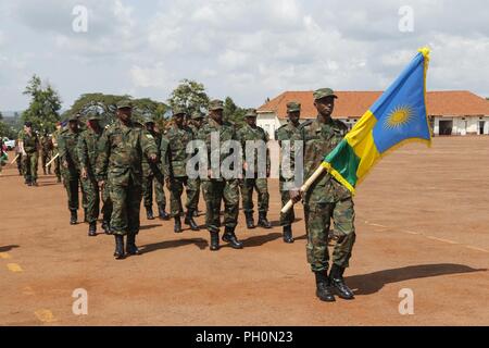 Rwanda Defence Force soldiers march off the parade field to finalize the opening ceremony for Justified Accord 2018 at the Ugandan Rapid Deployment Capability Center, Jinja, Uganda, June 18, 2018. Justified Accord is a two-week combined and joint exercise designed to demonstrate the capacity and capability of participants in peacekeeping operations and employing  African Union Mission in Somalia procedures. Stock Photo