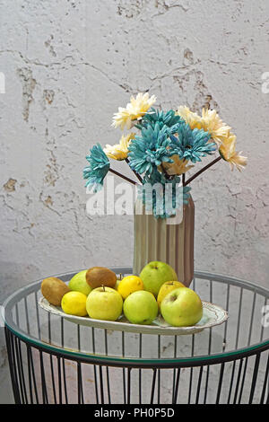 Flowers in vase and fruits at tray still life Stock Photo - Alamy