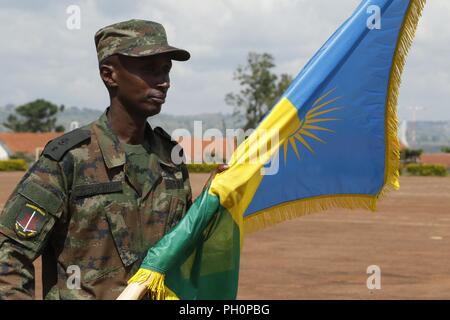 Rwanda Defence Force soldier, Justified Accord participant, holds the Rwanda flag in formation at the Justified Accord 2018 opening ceremony at the Ugandan Rapid Deployment Capability Center, Jinja, Uganda, June 18, 2018. JA18 brings together AMISOM troop contributing nations, partner nations from East Africa, and the U.S. to foster security cooperation while improving interoperability. Stock Photo
