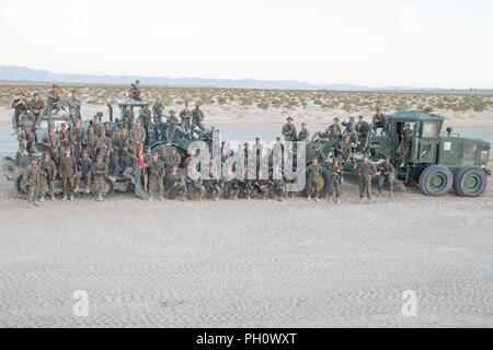 Marines with Engineer Company, Marine Wing Support Squadron 473, Marine Aircraft Group 41, 4th Marine Aircraft Wing, pose for a group photo in front of Outlying Landing Field Seagle, during Integrated Training Exercise 4-18 at Marine Corps Air Ground Combat Center Twentynine Palms, Calif., June 21, 2018. OLF Seagle last worked on 15 years ago when it was built is named after Navy Cross Recipient Capt Jeb Seagle, Cobra pilot killed in Grenada in 1983. Stock Photo