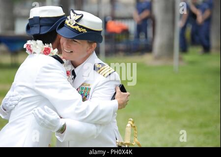 Capt. Charlene Downey and Capt. Monica Rochester hug following their change of command ceremony held at Coast Guard Sector Los Angeles-Long Beach in San Pedro, California, June 22, 2018. Rochester replaced Downey as the sector commander before Downey retired after 26 years of service.