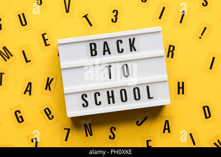 Back to school lightbox message on a bright yellow background Stock Photo