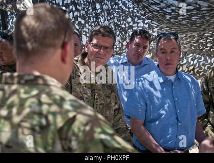 U.S. Army Gen. Joseph Votel, Central Command commander, and John Rood, Under Secretary of Defense for Policy, listen to a Coalition Advisor speak about the current state of military efforts at an outpost near Manbij, Syria, June 21, 2018. The city of Manbij has become an area of interest to many political entities since the Syrian Democratic Forces liberated the city from ISIS. Stock Photo