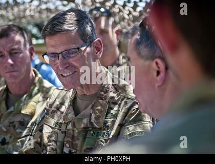 U.S. Army Gen. Joseph Votel, Central Command commander, speaks with John Rood, Under Secretary of Defense for Policy, and Coalition members during a meeting at an outpost near Manbij, Syria, June 21, 2018. After the meeting, Votel and other senior military leaders toured Manbij before having a meeting with the Manbij Military Council and Manbij Civil Council. Stock Photo