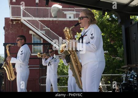 CARSON CITY, Nev. (June 23, 2018) Sailors assigned to Navy Band Southwest perform at McFadden Plaza Stage in support of Reno/Carson City Navy Week.  The Navy Office of Community Outreach uses the Navy Week program to bring Navy Sailors, equipment and displays to approximately 15 American cities each year for a week-long schedule of outreach engagements. Stock Photo