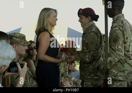 Mrs. Beth Hilbert, spouse of incoming commander Col. Joe Hilbert, receives flowers from Paratroopers of the 82nd Airborne Division Artillery, 82nd Airborne Division, during a change of command ceremony on Fort Bragg, North Carolina, June 22, 2018.  The ceremony marked the transfer of authority for the Army’s largest airborne artillery organization. Stock Photo