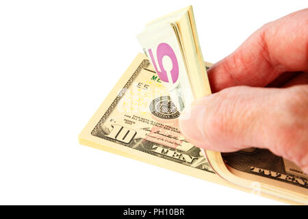 A senior person's hand counting a pile wodge of American currency money in US dollars dollar bills notes $ cash isolated on a white background. USA Stock Photo
