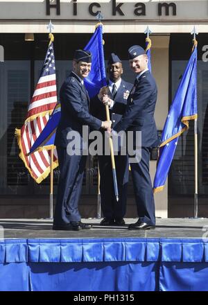 Lt. Gen. Kenneth Wilsbach, 11th Air Force commander, passes the Wing guidon to incoming 15th Wing commander, Colonel W. Halsey Burks on June 20, 2018 at the 15th Wing Change of Command ceremony on Hickam Field, Joint Base Pearl Harbor-Hickam, Hawaii. Col. Burks previously served as the Vice Commander of the 455th Air Expeditionary Wing, Bagram, Afghanistan. Stock Photo