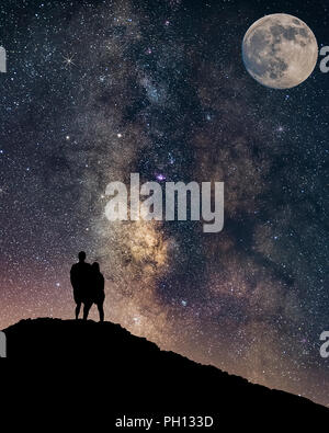 romantic Couple in love silhouette and the Milky way Stock Photo