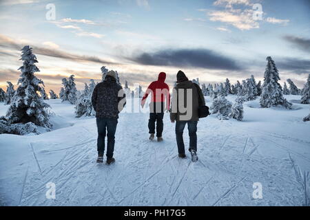 People walk in snowy winter mountains country, Krkonose, freezing weather Stock Photo