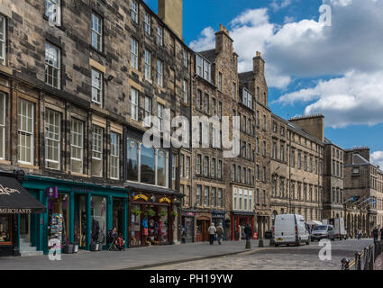Edinburgh, Scotland, UK - June 14, 2012; Stretch of tourist shops along the Royal Mile set in historic four to five stories high brown buildings. Stre Stock Photo