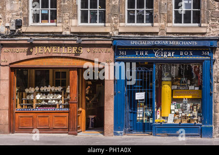 Edinburgh, Scotland, UK - June 14, 2012; closeup of Brown-beige Jewelry store and blue cigar and tobacco shop on Royal Mile, set on ground level of br Stock Photo