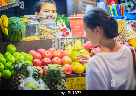 Bangkok, Thailand - March 2, 2017: Fresh red and green apples for sale on street in Bangkok, Thailand. Street fruit shop selling fresh apples, bananas Stock Photo