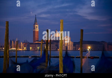 Chiesa di San Giorgio Maggiore, Venice, Italy, across the basin of St Mark at dawn: a line of moored gondolas in the foreground