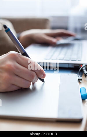 Close up view at graphic pen touching drawing board, illustrator hand work Stock Photo