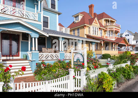 Colorfully painted Victorian houses, including the Oak House, serve as B&Bs on Seaview Avenue in Oak Bluffs Massachusetts on Martha's Vineyard. Stock Photo