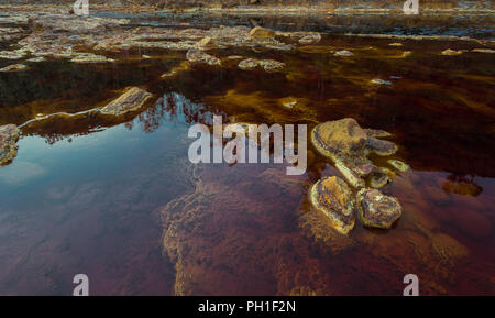 River of red water with orange stones for minerals, in whose bottom there are microorganisms studied by NASA due to its resemblance to Mars Stock Photo