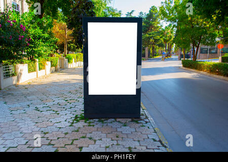 Vertical blank billboard with copy space for your text message or content, outdoors advertising mock up, public information board on city road. Empty  Stock Photo