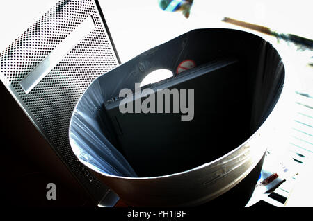 Old Laptop thrown in a waste bin at the office in the City area of London, England Stock Photo