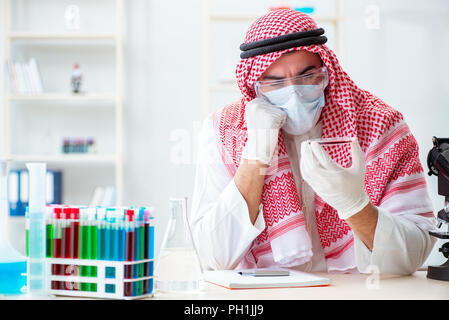 Arab doctor chemist studying new virus in lab Stock Photo