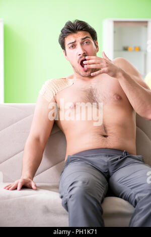 Man applying pepper Capsicum plaster to relieve pain Stock Photo