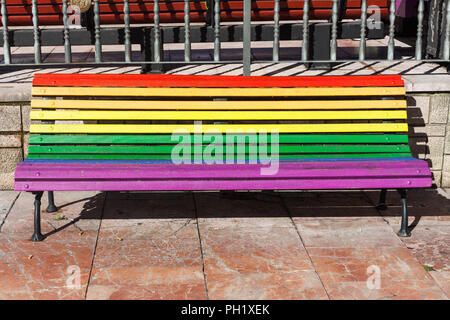 Rainbow bench painted in the colors of LGBT pride flag on Plaza de La Escandalera in Oviedo, Asturias, Spain Stock Photo