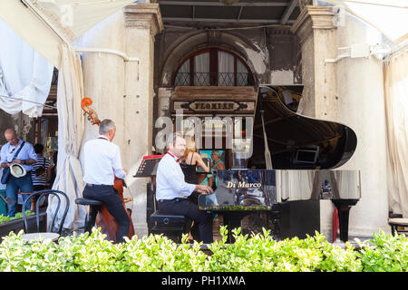 Musicins performing live outside Caffe Florian, Piazza San Marco, San Marco, Venice, Veneto, Italy reputedly the oldest cafe in the world Stock Photo