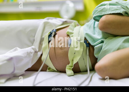 Pregnant woman undergoing cardiotocography to monitor the contractions of the uterus during childbirth. Stock Photo