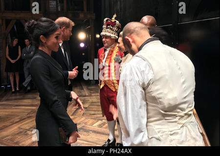 The Duke and Duchess of Sussex meeting King George and the cast