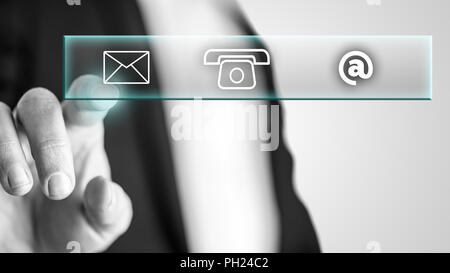 Male hand pressing with the finger on the mail icon from a contact section displayed on an interactive screen. Stock Photo