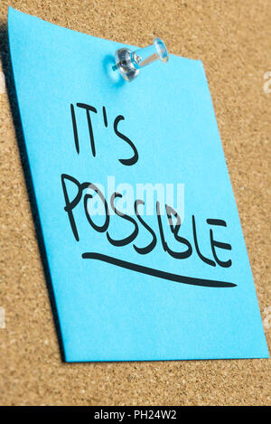It's possible sign on blue post it paper pinned on cork bulletin board. Stock Photo