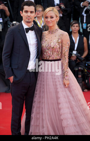 Venice, Italy. 29th Aug 2018. Actress Olivia Hamilton and director Damien Chazelle at the First Man Premiere, Opening Ceremony and Lifetime Achievement Award To Vanessa Redgrave at the 75th Venice Film Festival, Sala Grande on Wednesday 29th August 2018, Venice Lido, Italy. Credit: Doreen Kennedy/Alamy Live News Stock Photo