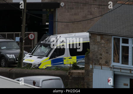 Newlyn Harbour, Cornwall, UK. 30th Aug, 2018. The border patrol vessel Vigilant was seen cruising into Newlyn harbour this morning, closely followed by a Catamaran which was berthed alongside the ship. Shortly afterwards police handcuffed and escorted off 2 men. An NCA spokesperson said: “Five men have been arrested on suspicion of drug trafficking offences and NCA officers, with support from Border Force Maritime and Deep Rummage specialists, are at Newlyn harbour, as investigation continues”. Credit: Simon Maycock/Alamy Live News Stock Photo
