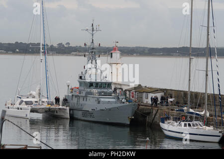 Newlyn Harbour, Cornwall, UK. 30th Aug, 2018. The border patrol vessel Vigilant was seen cruising into Newlyn harbour this morning, closely followed by a Catamaran which was berthed alongside the ship. Shortly afterwards police handcuffed and escorted off 2 men. An NCA spokesperson said: “Five men have been arrested on suspicion of drug trafficking offences and NCA officers, with support from Border Force Maritime and Deep Rummage specialists, are at Newlyn harbour, as investigation continues'. Credit: Simon Maycock/Alamy Live News Stock Photo