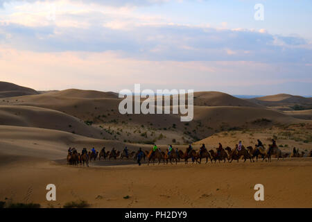 Inner Mongolia, Inner Mongolia, China. 30th Aug, 2018. Inner Mongolia, CHINA-Scenery of Resonant Sand Gorge in north China's Inner Mongolia. Resonant Sand Gorge means ''the desert with horns'' in the Mongolian language. Located n the east side of Kubuqi Desert, this site is in a crescent shape with gold color. Resonant Sand Gorge is featured by its amazing desert landscape and the whispering sand dunes. In the conditions of the dry climate, people will hear sounds like a bugle and drumbeat in the sand if they surf along the slopes of the dunes. Credit: SIPA Asia/ZUMA Wire/Alamy Live News Stock Photo