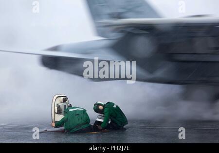 Atlantic Ocean. 28th Aug, 2018. ATLANTIC OCEAN (Aug. 28, 2018) Aviation Boatswain's Mates (Equipment) Airman Megan Brewington, left, and Abraham Amoateng conduct communications as an F/A-18F Super Hornet from the Jolly Rogers of Strike Fighter Squadron (VFA) 103 launches from the flight deck of the Nimitz-class aircraft carrier USS Abraham Lincoln (CVN 72). Abraham Lincoln is underway with Carrier Strike Group 12 (CSG 12) conducting Operational Test-1 (OT1) for the F-35C Lightning II Joint Strike Fighter. (U.S. Navy photo by Mass Communication Specialist 1st Class Brian M. Wilbur/Released) Stock Photo