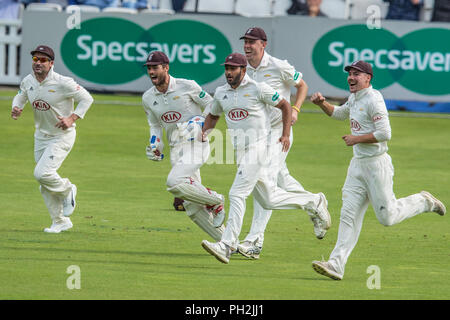 London, UK. 30 August 2018. Surrey players rush to Conor McKerr after he gets the wicket of Billy Root bowling for Surrey against Nottinghamshire on day two of the Specsavers County Championship game at the Kia Oval. David Rowe/Alamy Live News. Stock Photo