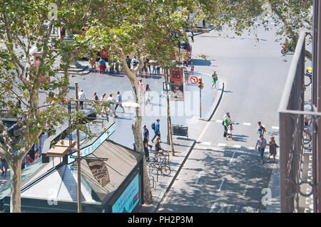 BARCELONA, SPAIN - JULY 31, 2012: View over the avenue La Rambla witth pedestrian crossing on a sunny summer day on July 31, 2012 in Barcelona, Spain. Stock Photo