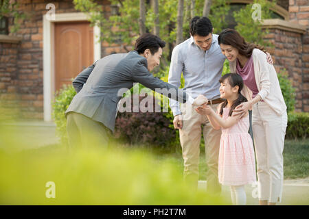 Realtor giving young family keys to new house Stock Photo