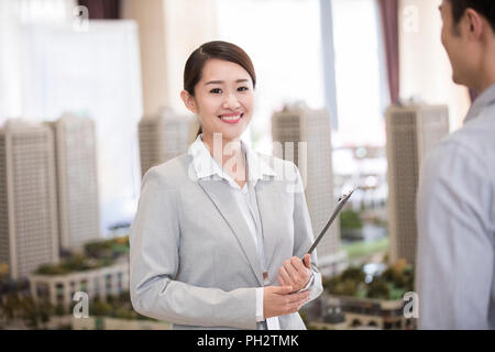Confident realtor in sales center Stock Photo