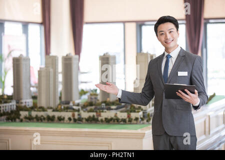 Confident realtor in sales center Stock Photo