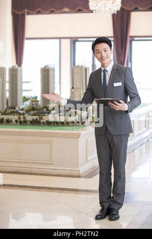 Confident realtor in sales center Stock Photo