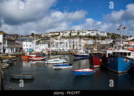 Fishing boats at anchor and lined up in the outer harbour at Mevagissey on the Cornish coats in England Stock Photo