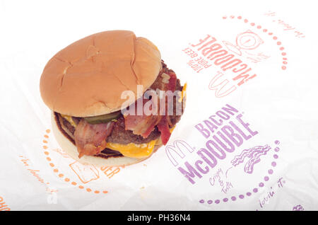 McDonalds Bacon McDouble Cheeseburger with ketchup, onions, pickle and yellow cheese on wrapper Stock Photo