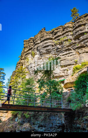 Hikers along the trail to Pravčická brána in Bohemian Switzerland, a picturesque region in the north-western Czech Republic. Stock Photo