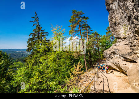 Hikers along the trail to Pravčická brána in Bohemian Switzerland, a picturesque region in the north-western Czech Republic. Stock Photo