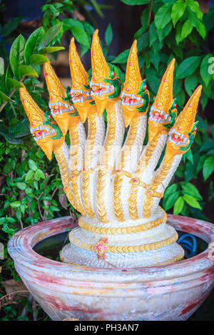 Golden statue of seven head of Naga fountain that decorated in the garden. Stock Photo